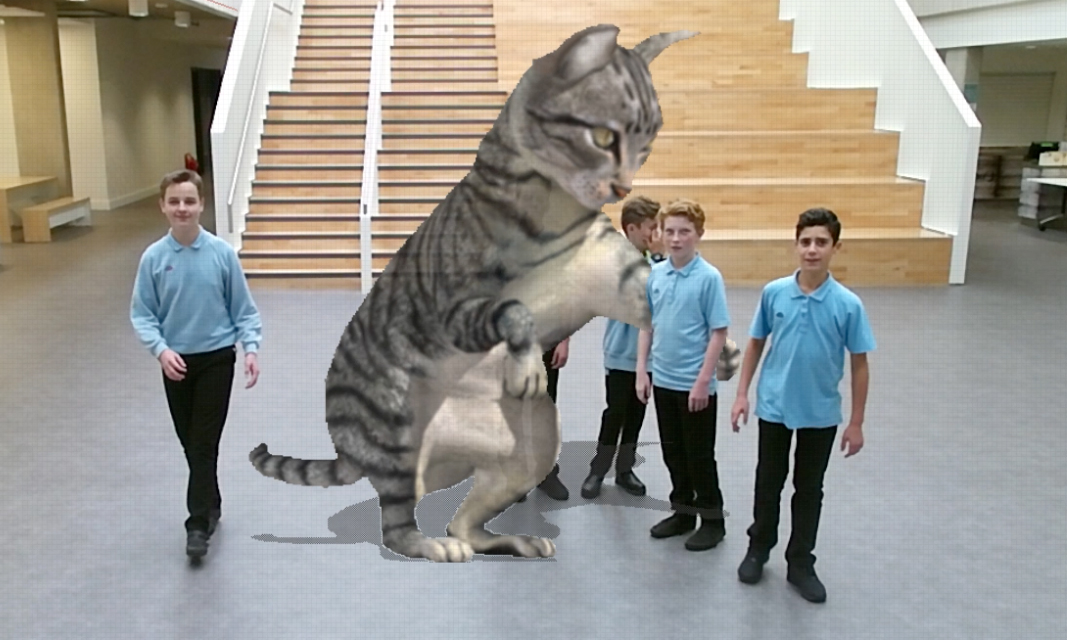 Students interacting with Cinder in school's central space